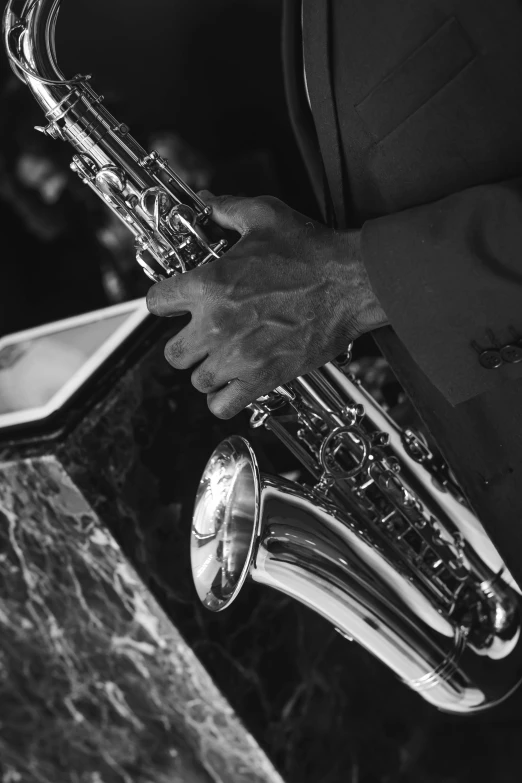 a man that is holding a saxophone in his hands