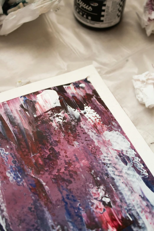 a piece of art sitting on top of a table, inspired by Julian Schnabel, unsplash, high detailed print, jelly - like texture. photograph, medium close up portrait, limited colour palette