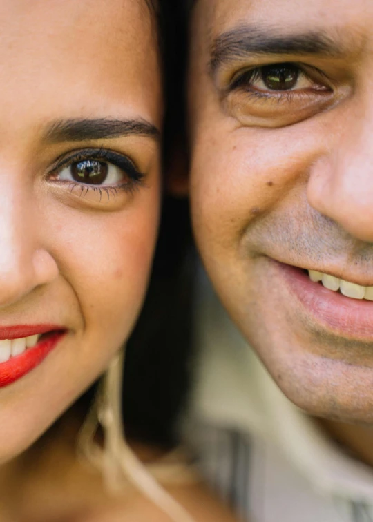 a man and a woman posing for a picture, an album cover, pexels, flawless olive skin, colourful close up shot, family portrait, cheeky smile with red lips