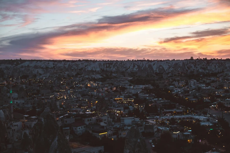 an aerial view of a city at sunset, by Carey Morris, pexels contest winner, hurufiyya, cave town, sleepy, high resolution photo, aykut aydogdu