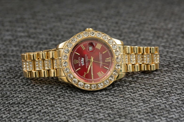 a close up of a watch on a table, instagram, renaissance, wearing red formal attire, realistic gold, rolex, ebay listing thumbnail