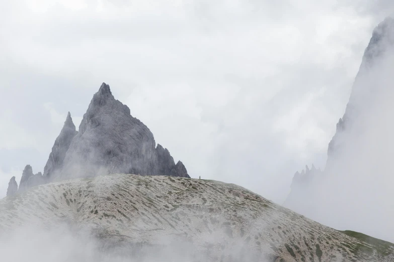 a mountain that has a foggy ground in it