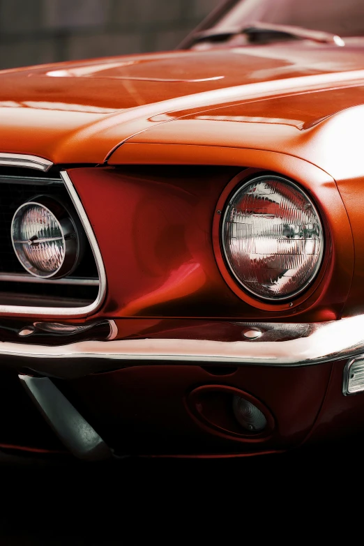 an old orange mustang car with its hood turned
