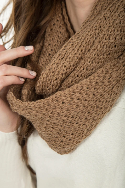 woman in white sweater holding onto her shawl