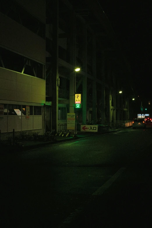 the back of a bus at night as seen from across a road