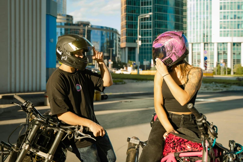 a man talking on a cell phone next to a woman on a motorcycle, by Adam Marczyński, pexels contest winner, realism, wearing skate helmet, in a cybercity, full faced, sassy pose