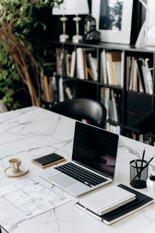 a laptop computer sitting on top of a white table, trending on pexels, ivory and black marble, interior of a library, dwell, carefully drawn