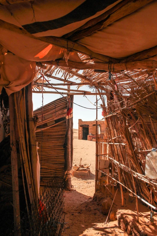 a man that is standing in the dirt, temporary art, doors to various living quarters, in a dusty red desert, covered with wires, slide show