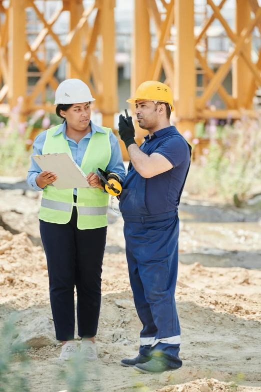 a couple of people that are standing in the dirt, yellow hardhat, talking, thumbnail, charts