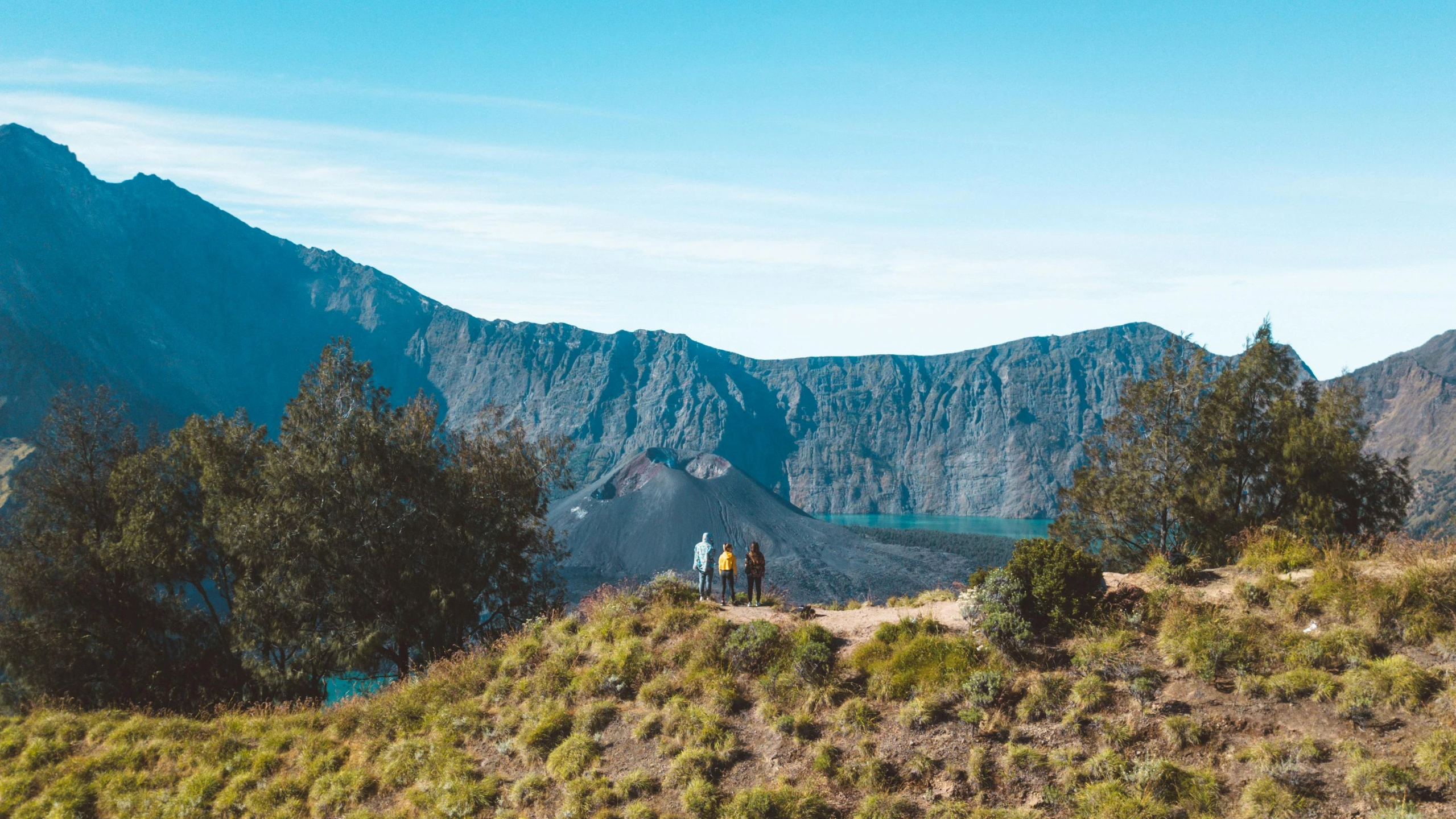 a man riding a horse down a mountain trail