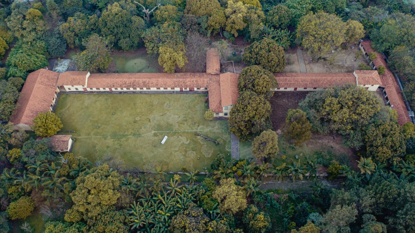 a building surrounded by trees in a field