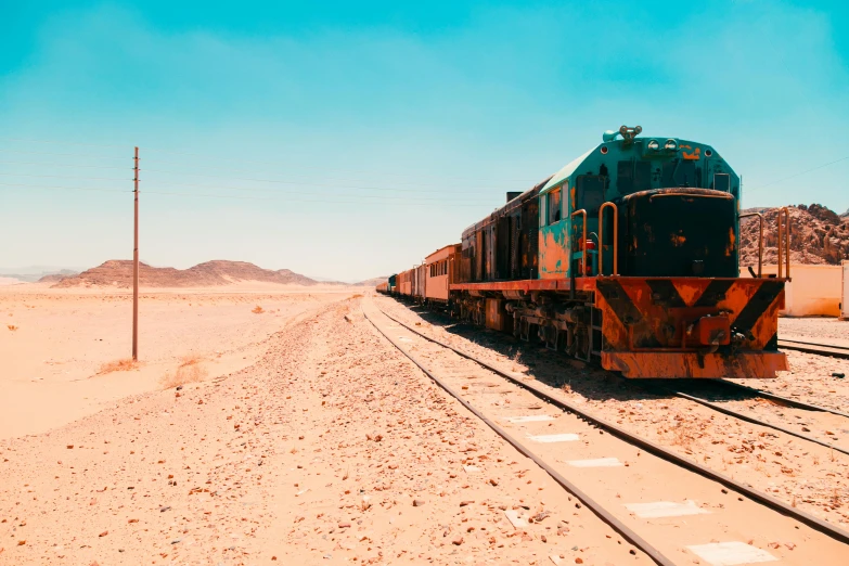 a train traveling down train tracks in the desert, teal and orange colours, red sea, desert circus, 🚿🗝📝