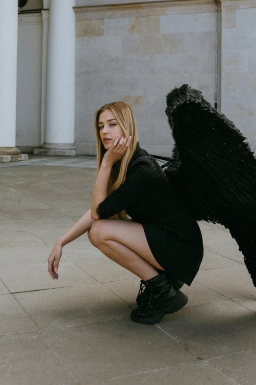 a woman kneeling down next to a black bear, an album cover, by Sebastian Vrancx, pexels contest winner, angel with black wings, sydney sweeney, at a fashion shoot, university