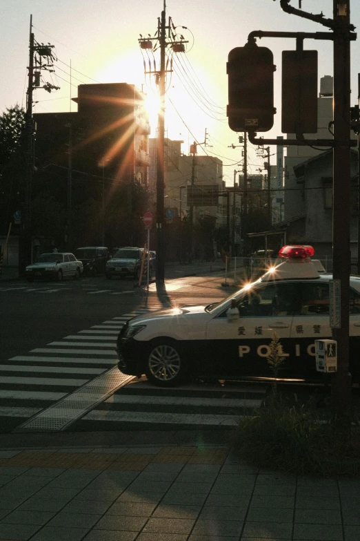 a police car on a busy road in the evening