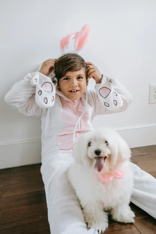 a little girl sitting on the floor with a white dog, wearing a bunny suit, teen boy, wearing nanotech honeycomb robe, easter