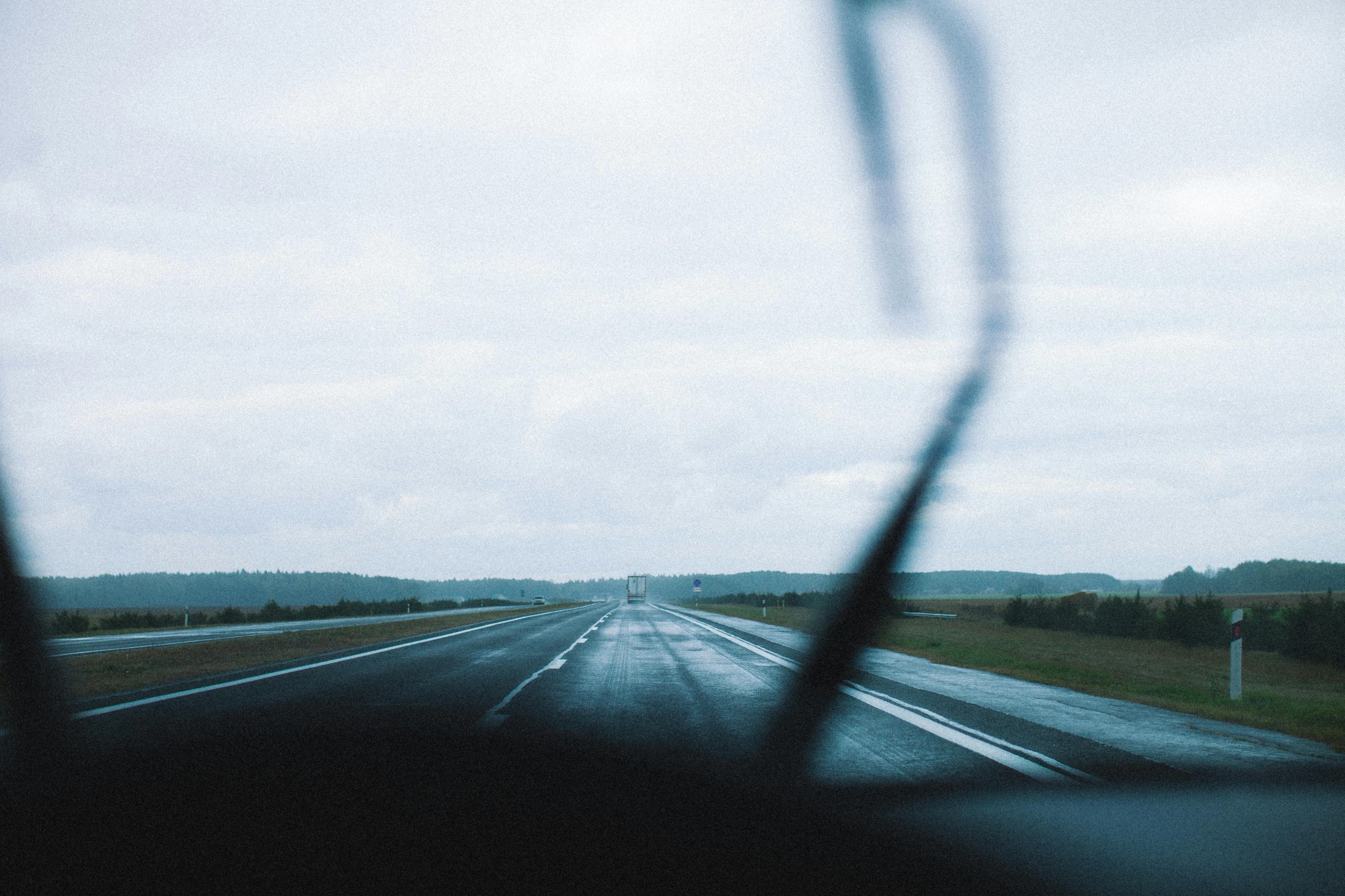 a view of a highway through the windshield of a car, an album cover, unsplash, dreary, runway, head down, jovana rikalo