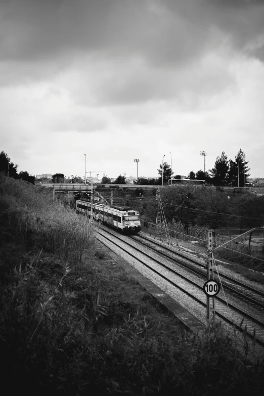 a black and white picture of a train on train tracks