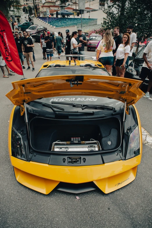 a yellow car with the hood up