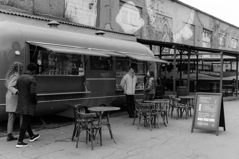 black and white po of people standing outside of a diner