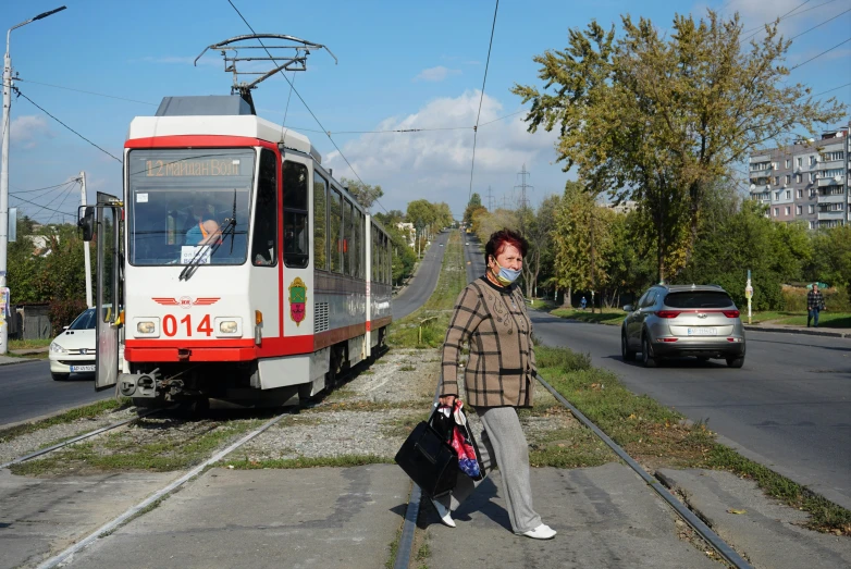 man with bag on head while standing in middle of street