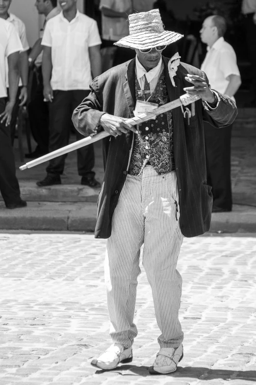 black and white po of a street performer using a stick