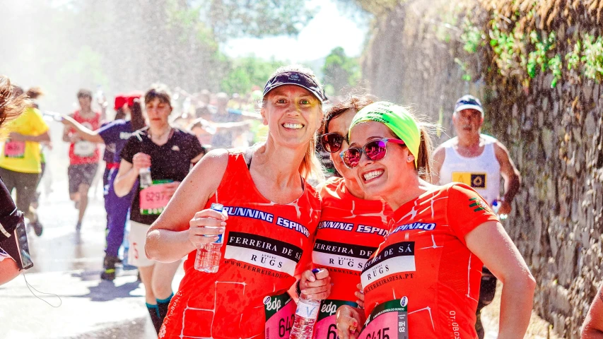 two women standing next to each other at the start of a race