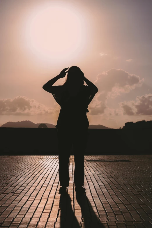 a person with her arms behind her head