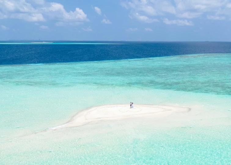 an island is in the middle of a vast body of water