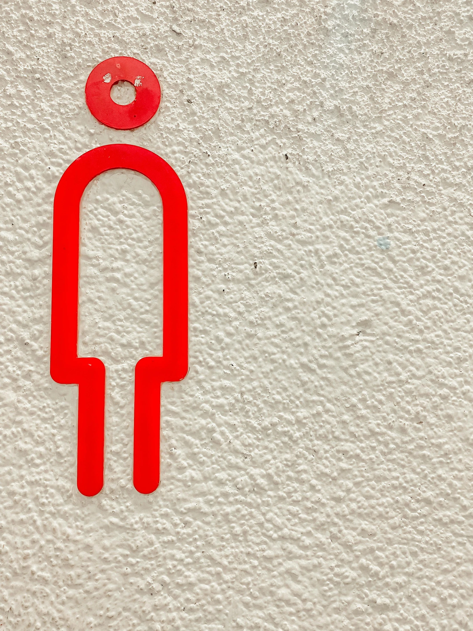 a close up of a toilet sign on a wall, pexels contest winner, elongated figure, electrode, 1 figure only, rounded lines