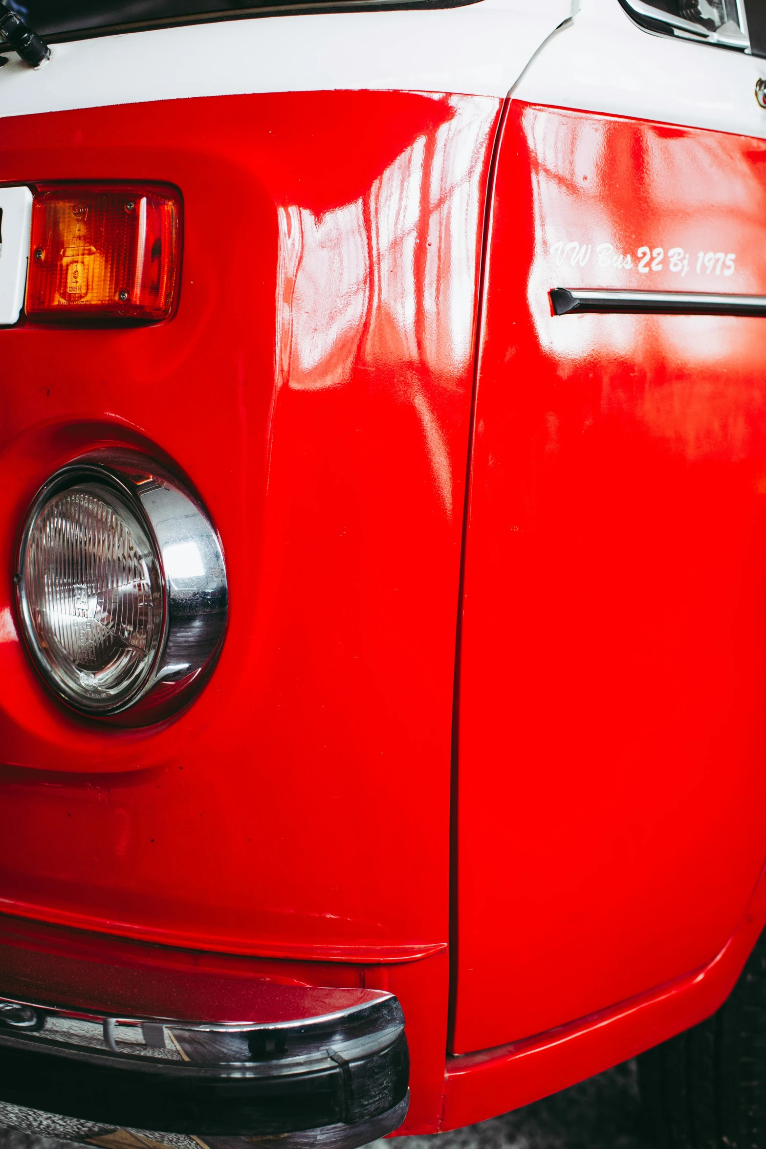 a red vw bus parked on the side of the road, by Sven Erixson, pexels contest winner, hyperrealism, skin detail, side lights, silver red, dynamic closeup