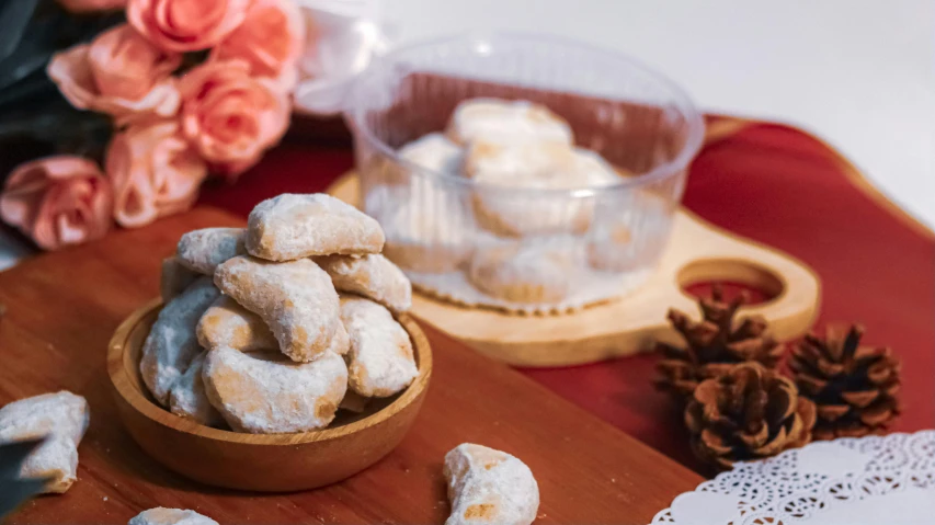 a wooden cutting board topped with cookies on top of a table, baroque, kuntilanak, background image, feature, vanilla