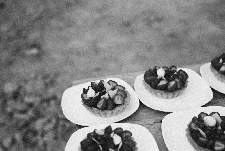 a black and white photo of desserts on plates, by Jan Kupecký, strawberry fields forever, tri - x film, al fresco, uploaded