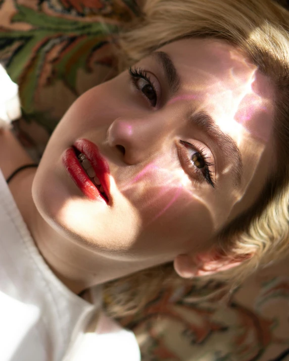 a close up of a person laying on a couch, inspired by Elsa Bleda, light-red lips, standing under a beam of light, kiernan shipka, nonbinary model