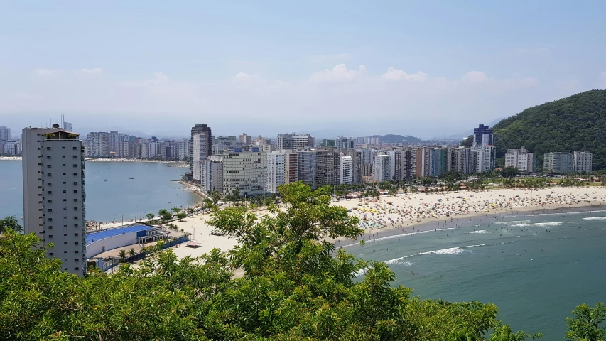 a view of the beach, city buildings, and ocean