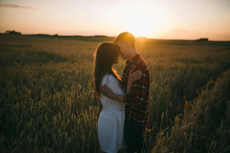 a couple kissing in a field at sunset, pexels contest winner, attractive girl, owen klatte, slightly pixelated, confident looking