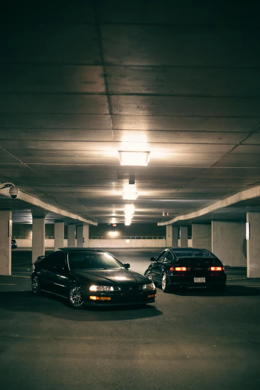 two cars are parked in the parking garage