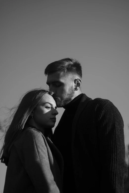 a man and woman standing next to each other, a black and white photo, pexels contest winner, romanticism, profile image, music video, man, cold breath