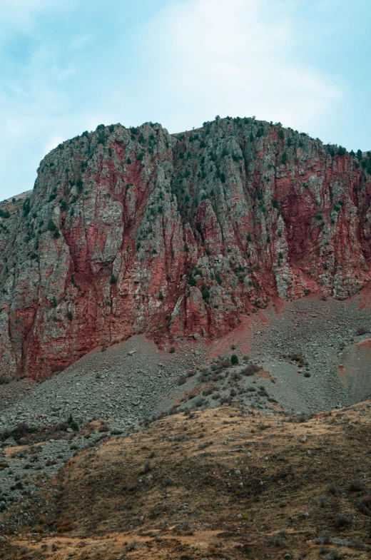 mountains are covered in red and green rocks