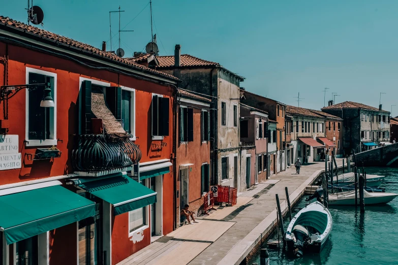 a couple of boats that are in the water, inspired by Quirizio di Giovanni da Murano, pexels contest winner, standing in a township street, thumbnail, viridian and venetian red, profile image