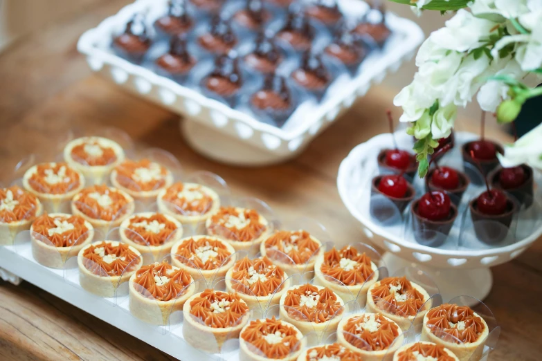 a close up of a tray of food on a table, cakes, profile image, extra details