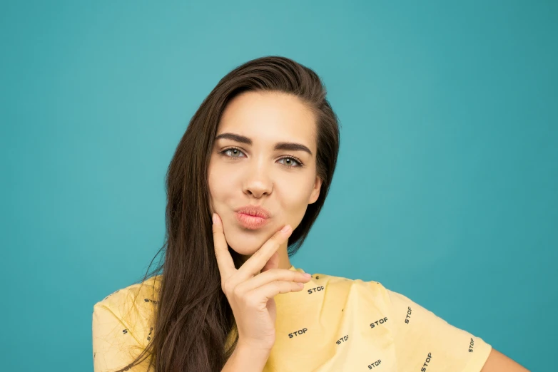 woman with long hair holding her chin up