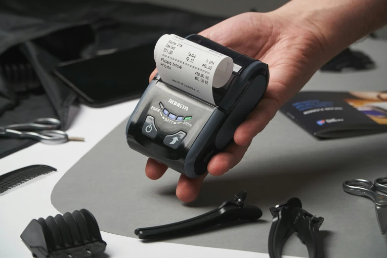 a close up of a person holding a cell phone, ergodox, with a xerox machine, holding a battery, merlin