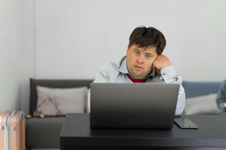 a man sitting in front of a laptop computer, inspired by Dan Content, looking tired, an overweight, some people are sitting, profile image