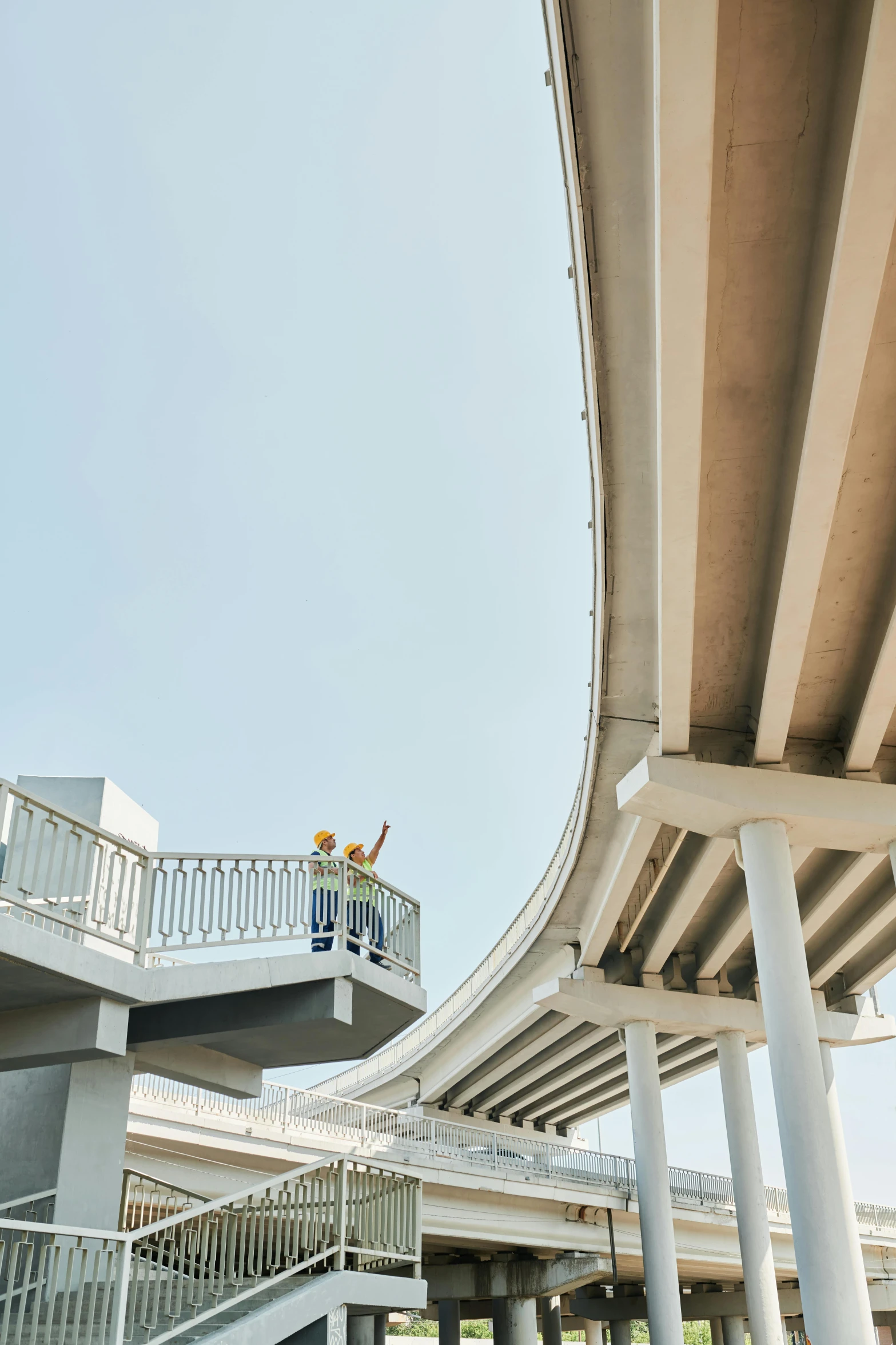 a couple of people standing on top of a bridge, white concrete, infrastructure, curving, instagram post