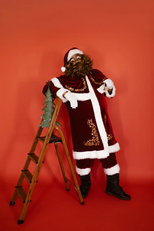 santa clause poses on a ladder with his arms outstretched