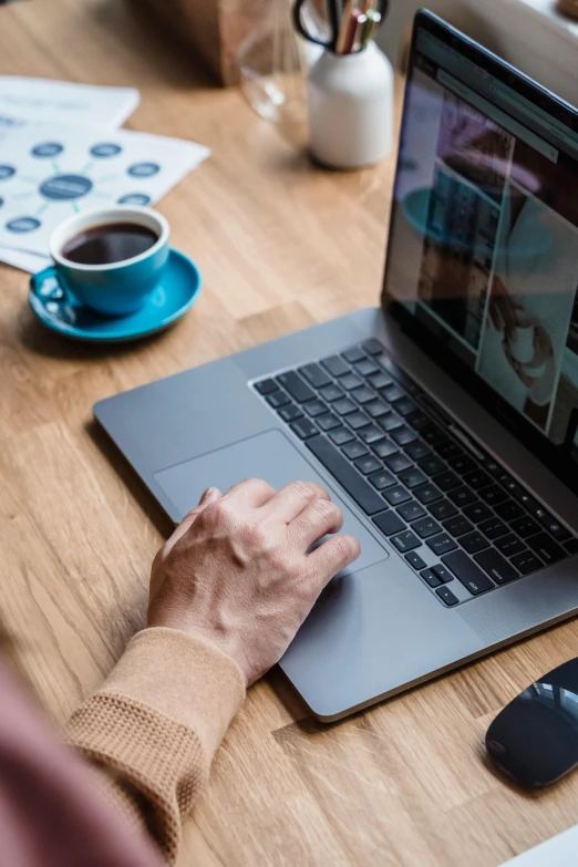 a person sitting at a table working on a laptop, trending on pexels, avatar image, full frame image, background image, table in front with a cup