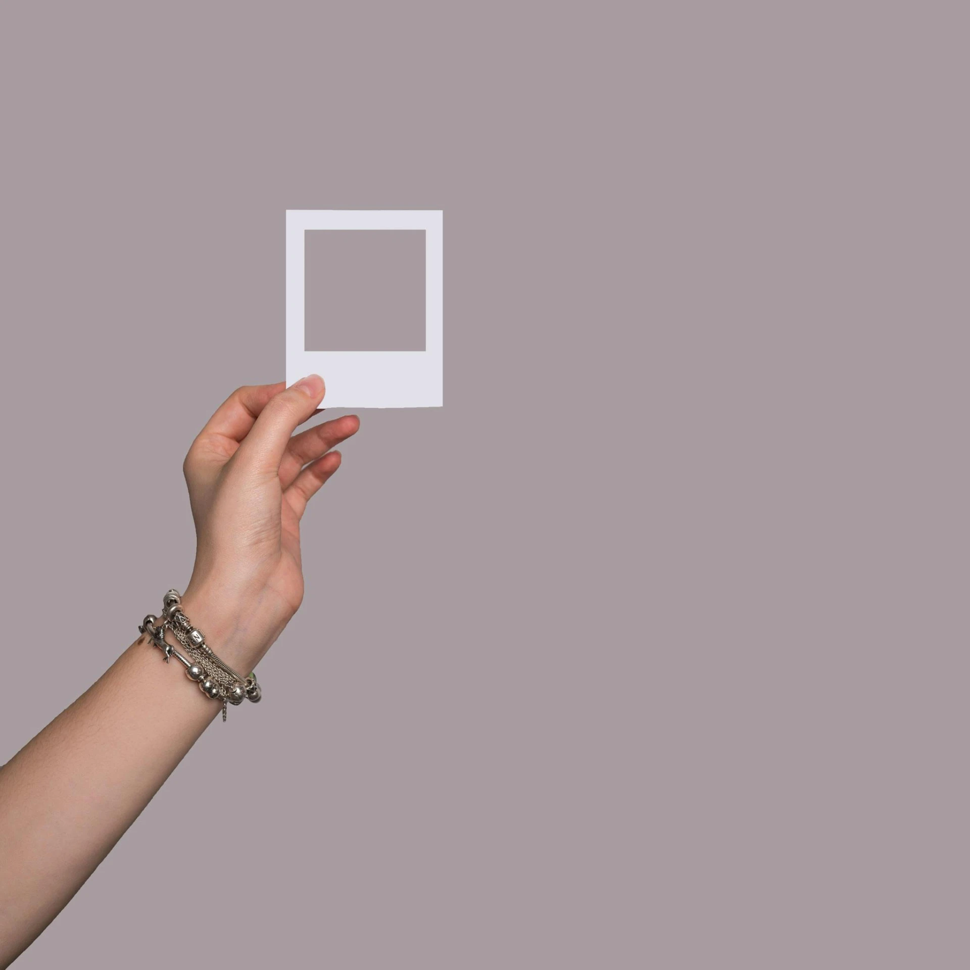 a person holding a white square in their hand, a polaroid photo, trending on pexels, aestheticism, flat grey background, jewelry, transparent backround, square pictureframes