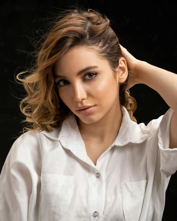 a woman in a white shirt posing for a picture, a colorized photo, by irakli nadar, trending on pexels, estefania villegas burgos, middle eastern skin, hybrid of gal gadot, androgynous person