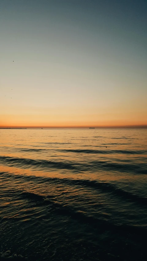 a person riding a surfboard on top of a body of water, minimalism, golden hour cinematic, harbor, instagram photo, color graded