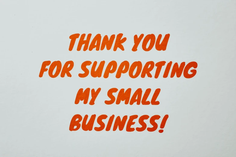 a sign that says thank you for supporting my small business, an album cover, by David Small, happening, wearing an orange t shirt, avatar image, streetwear, detail shot